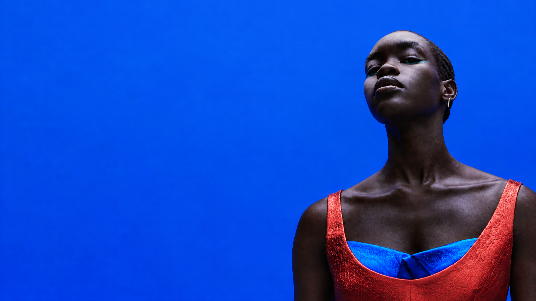 Woman in red against a cobalt-blue backdrop